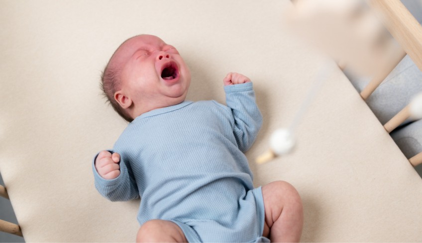 infant cries when put down